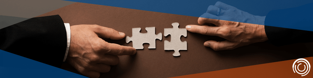 Puzzle pieces being placed together by two different hands to signify a merger, a valuation can make the pieces fit together.
